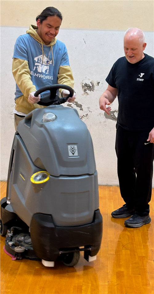 man operating floor cleaner