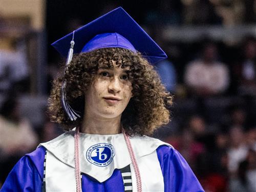 A student with an International Baccalaureate sash