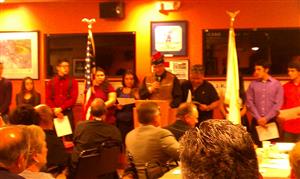 A veteran honors students with scholarships