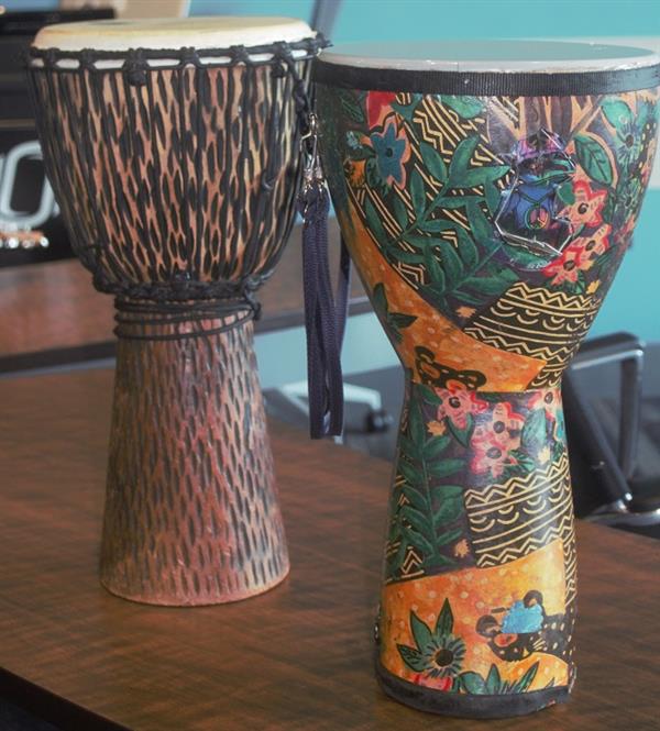 Two djembe drums with decorations