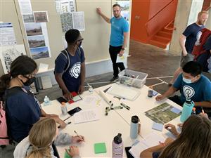 Students work on their revitalization plans for the 24th and Miami building at BVH Architecture.
