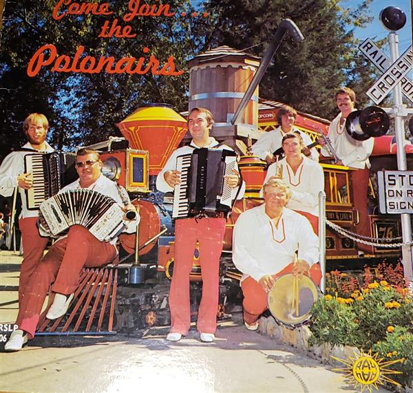 Polonairs album cover featuring band with instruments on a locomotive