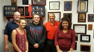 Serena B., Drake H., & Ezmi B.  photographed with Douglas County Treasurer John Ewing and Teacher Jeff S. 