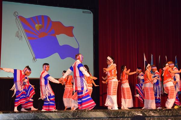 A group of people perform the don dance in traditional dress