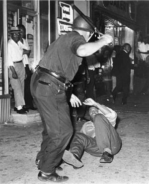 A police man beats a protestor