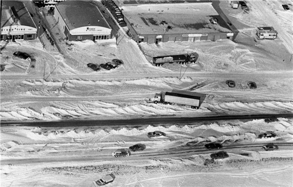 Overhead image of buildings and vehicles in blizzard