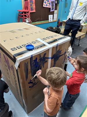 children playing with carboard box