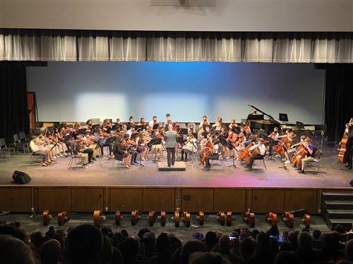 Students playing on stage during a Strings concert.